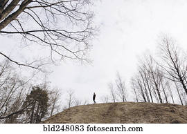 Distant woman standing on hill