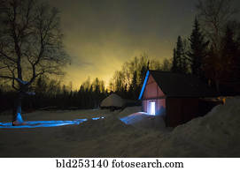 Light glowing in remote barn in winter