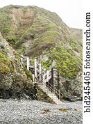 Staircase to hill on rocky beach