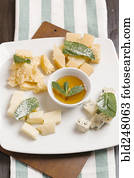 Variety of cheeses on plate with sauce