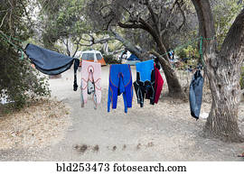 Wet clothing hanging on clothesline near camping tent