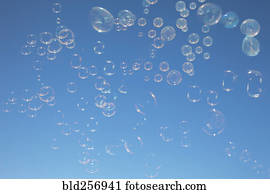 Bubbles floating in blue sky