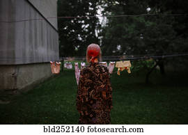 Caucasian woman staring at clothesline