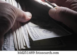 Hands of man counting money