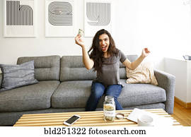 Mixed race woman celebrating with money for college Mixed race woman celebrating with money for college