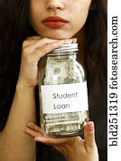Portrait of mixed race woman holding jar of money for student loan Portrait of mixed race woman holding jar of money for student loan