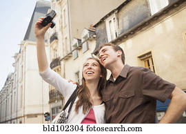 Caucasian couple taking self-portrait