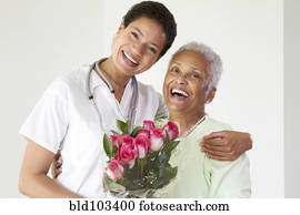 African American woman hugging nurse