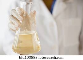 Cape Verdean scientist holding chemical in beaker