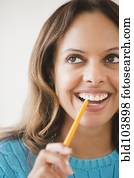 Cape Verdean woman biting pencil