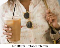 Cape Verdean woman drinking iced coffee