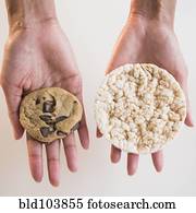 Cape Verdean woman holding cookie and rice cake