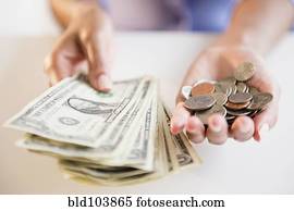 Cape Verdean woman holding dollar bills and coins