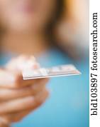 Cape Verdean woman holding out credit card