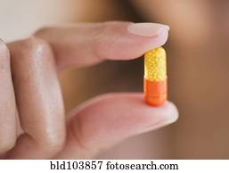 Cape Verdean woman holding pill capsule