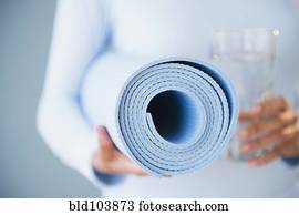 Cape Verdean woman holding yoga mat