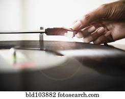 Cape Verdean woman listening to vinyl record