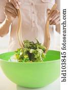 Cape Verdean woman tossing a salad