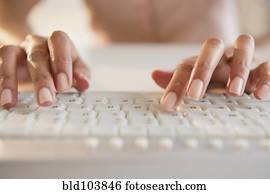 Cape Verdean woman typing on keyboard