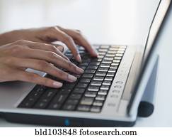 Cape Verdean woman typing on laptop