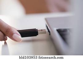 Cape Verdean woman using USB device