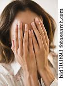 Cape Verdean woman with hands over face