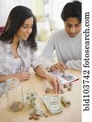 Mixed race couple counting money