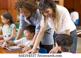 Hispanic teachers helping students