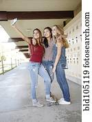 School friends taking self-portrait with cell phone