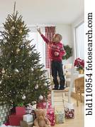 African American boy decorating Christmas tree