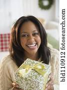 African American woman holding Christmas present
