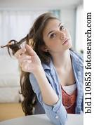 Hispanic girl twirling her hair