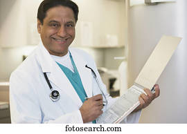 Middle-aged Indian male doctor with chart