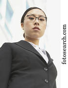 Low angle view of Asian businesswoman outdoors