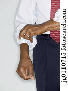 Man rolling up his shirt sleeve