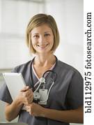 Caucasian nurse holding digital tablet