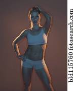 Caucasian woman wearing sports bra and shorts