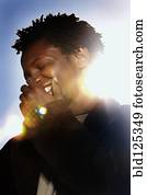 Black man laughing outdoors Black man laughing outdoors