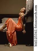 Well-dressed Caucasian couple hugging in bedroom