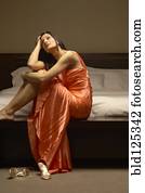 Well-dressed Caucasian woman waiting in bedroom