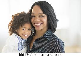 Portrait of smiling African American mother and daughter