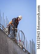 Caucasian worker on top of building