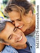 Caucasian couple smiling outdoors Caucasian couple smiling outdoors
