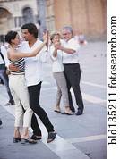 Couples dancing in town square