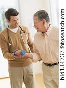 Senior Caucasian man working with physical therapist