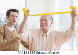 Senior Caucasian man working with physical therapist