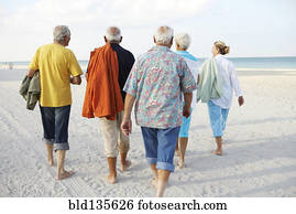 Senior friends walking on beach