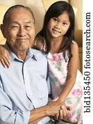 Senior man and granddaughter holding hands Senior man and granddaughter holding hands