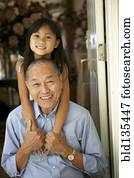 Senior man and granddaughter hugging Senior man and granddaughter hugging