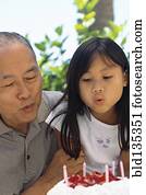 Senior man and granddaughter celebrating birthday Senior man and granddaughter celebrating birthday